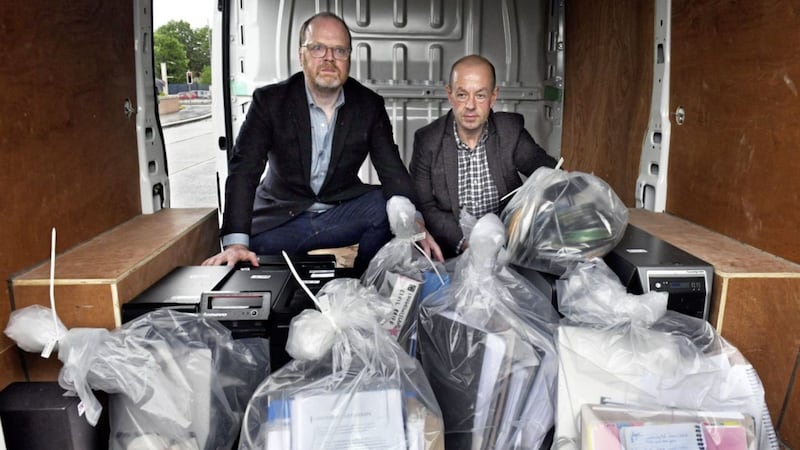 Journalists Trevor Birney, (left), and Barry McCaffrey leave Castlereagh Police Station in east Belfast with materials and computers after a High Court ruling that the PSNI had no legal right to the materials. Picture by Alan Lewis- Photopress 