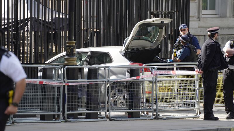 Police at the scene after a car crashed into the gates of Downing Street (PA)