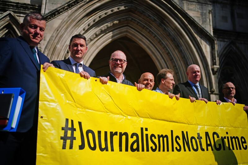 Barry McCaffrey, centre, and Trevor Birney, third left, with lawyers and supporters outside the Royal Courts of Justice in London .