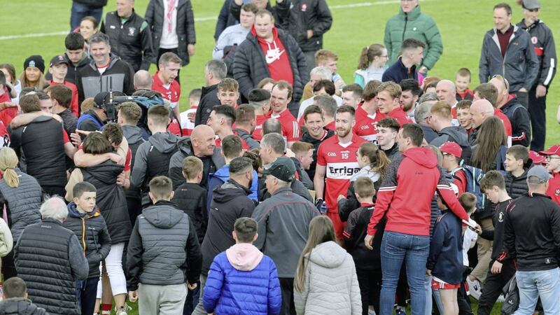 Derry players and supporters mingle on the pitch in Omagh after their win over Tyrone on Sunday. Picture by Margaret McLaughlin 