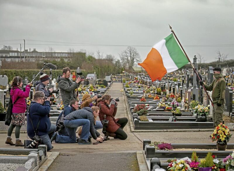 Press photographers capture images of a masked colour party dressed in military-style regalia at a republican commemoration in Lurgan, Co Armagh to mark the 100th anniversary of the 1916 Easter Rising. PICTURE: MAL MCCANN 