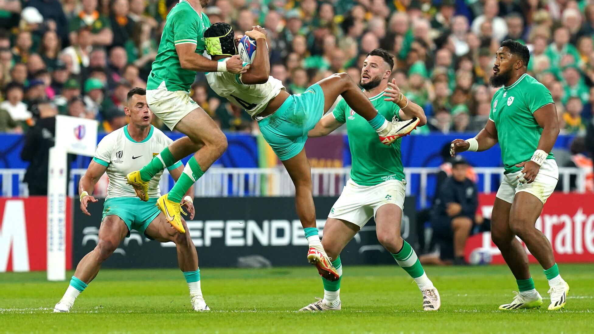 South Africa's Kurt-Lee Arendse claims the ball with pressure from Ireland's Hugo Keenan during the Rugby World Cup 2023, Pool B match at the Stade de France in Paris