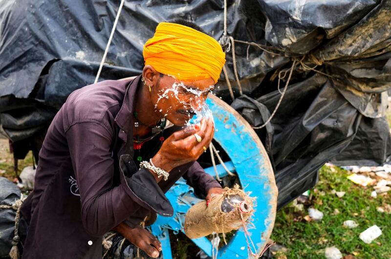 A man splashes water on his face to cool himself in Lalitpur district in northern Uttar Pradesh state 