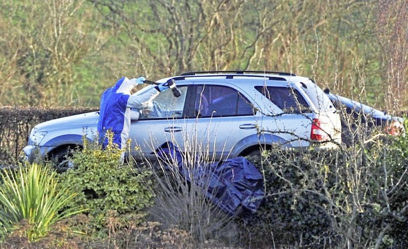 Police forensic experts examine a car involved in the murder of Nelson Cheung near Randalstown. Picture by Justin Kernoghan