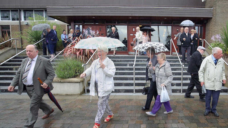 People leaving Sunday morning Mass at St Michael the Archangel on Finaghy Road North PICTURE: Cliff Donaldson 