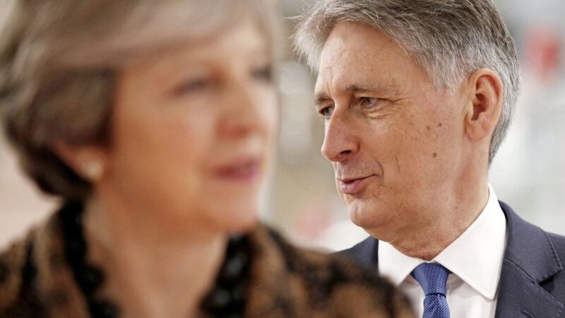 PENNY FOR YOUR THOUGHTS? A pensive Chancellor Philip Hammond, ahead of tomorrow&#39;s Budget, joins Prime Minister Theresa May on a visit to an engineering training facility in the West Midlands 