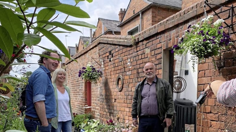 Gardening expert Diarmuid Gavin (left) pictured on Wednesday when he visited the famous blooming alley in south Belfast. The presenter is pictured with residents Fiona Muldoon and Paddy McAree. Picture: Andy McCague 