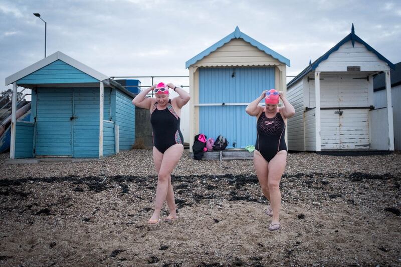 Swimmers take their daily dip in the Thames estuary at Thorpe Bay near Southend-on-Sea