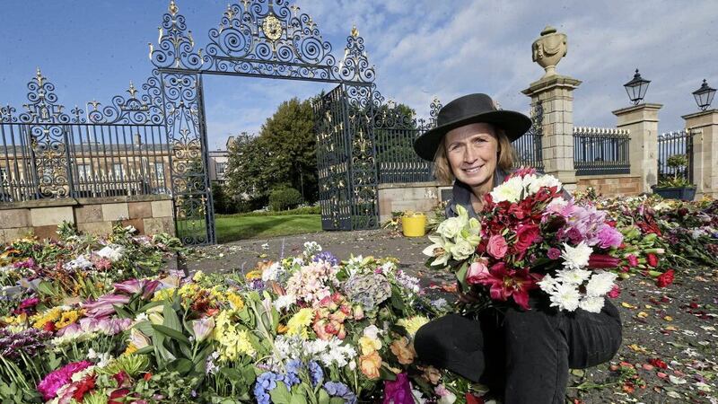 Claire Woods, garden manager at Hillsborough Castle, prepares to direct staff to move 40,000 bunches of flowers placed outside Hillsborough Castle in Co Down following the death of the Queen are being removed from the gates. Picture by Hugh Russell. 