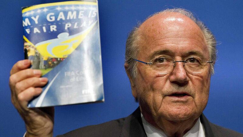 FIFA President Sepp Blatter, pictured holding the FIFA Code of Ethics, is under growing pressure to stand down Picture by Alessandro Della Bella/AP 