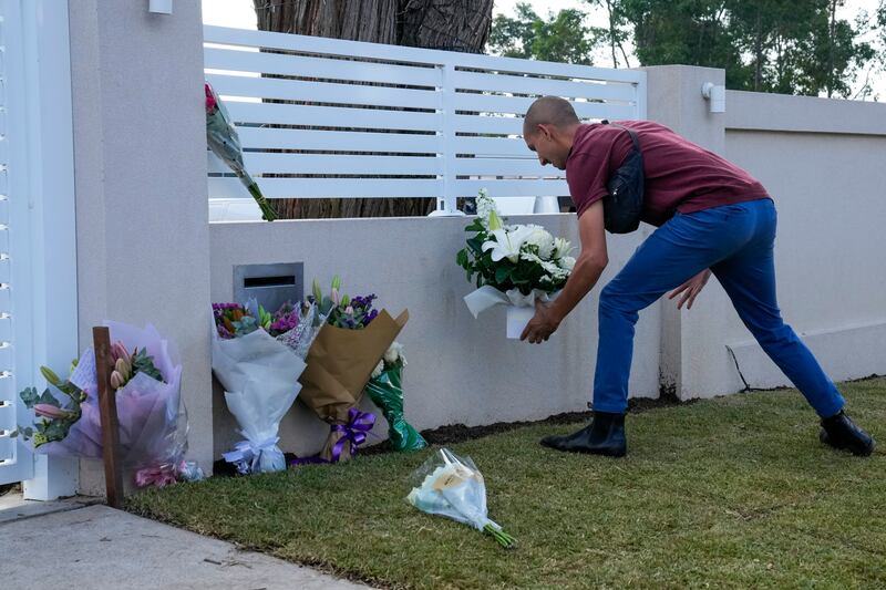 A man places flowers outside the Christ the Good Shepherd church. The bishop injured in the attack gave his first sermon since the stabbing (AP Photo/Mark Baker)
