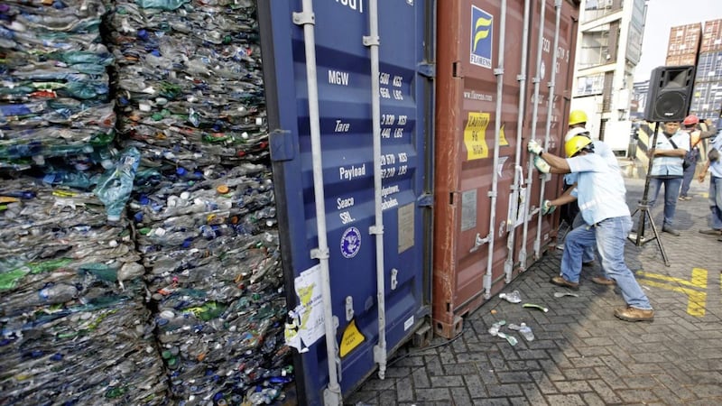 Indonesian workers lock containers full of plastic at Tanjung Priok port in Jakarta Picture by Achmad Ibrahim/AP 