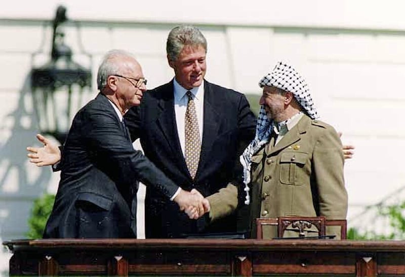 US President Bill Clinton presides over a handshake sealing the Oslo accords between Israeli prime minister Yitzhak Rabin and PLO leader Yasser Arafat at the White House in 1993 