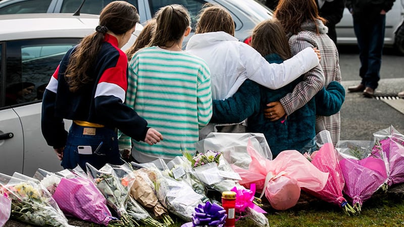 &nbsp;A group of teenage girls escorted by their families leave floral tributes at the entrance of the Greenvale Hotel in Cookstown. Picture by Liam McBurney/PA Wire