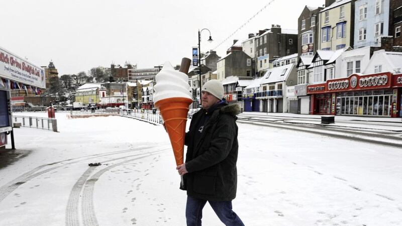 Brett Canham prepares his catering stall on Scarborough seafront, as heavy snowfall is affecting roads across the UK 