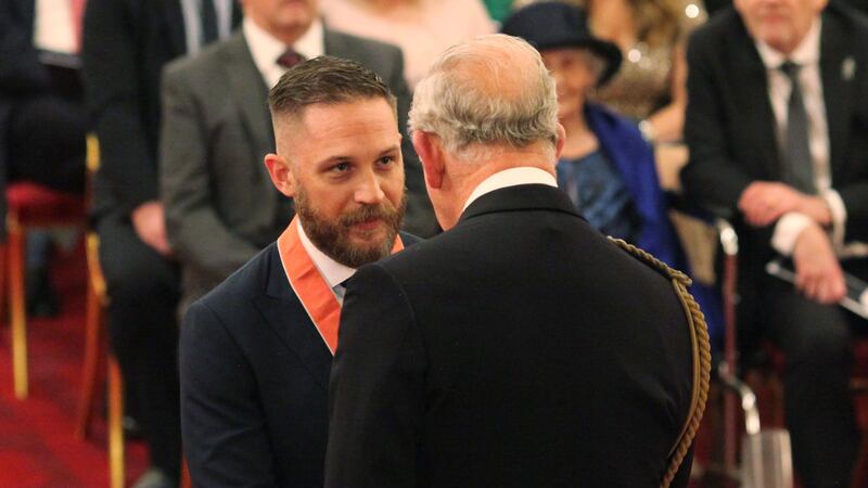 The actor, who declined to talk to the waiting press, was presented with his CBE insignia by the Prince of Wales.