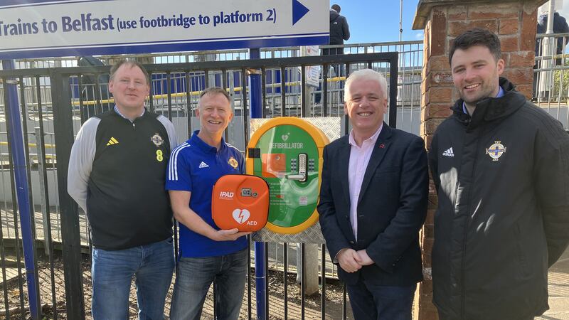 Gary McAllister and Andrew Cuthbert from the Amalgamation of Official NI Supporters’ Clubs, Fearghal McKinney of BHFNI and James Thompson from the IFA at the newly installed defibrillator at Adelaide halt