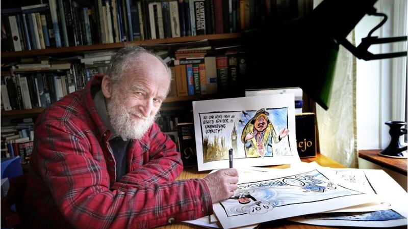 Irish News cartoonist Ian Knox with some of his recent work. Picture by Hugh Russell 