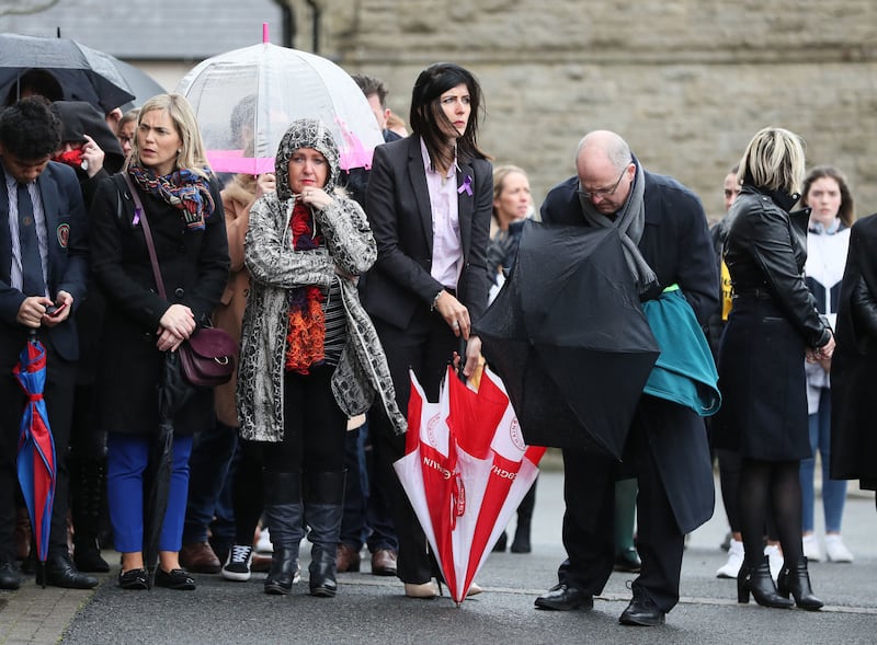 Catherine McHugh (holding red and whit umbrella), principal of St Patrick's College, Dungannon at the funeral of Morgan Barnard. Picture by Brian Lawless, Press Association
