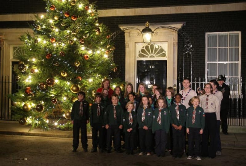 Sarah Brown, the wife of Prime Minister Gordon Brown, and a group of Guides turn on the Christmas tree lights in Downing Street, 