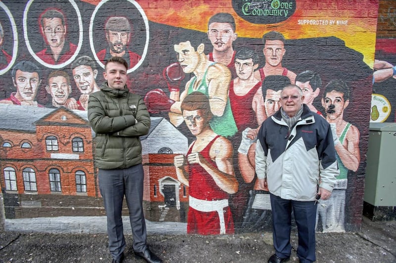 Irish News placement student Sean Whelan and his uncle Pat Burns are pictured at the boxing mural on Oldpark Avenue, north Belfast. Picture by Mal McCann