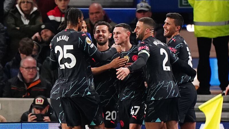 Phil Foden, centre, scored twice at Brighton to help Manchester City move a point behind Premier League leaders Arsenal