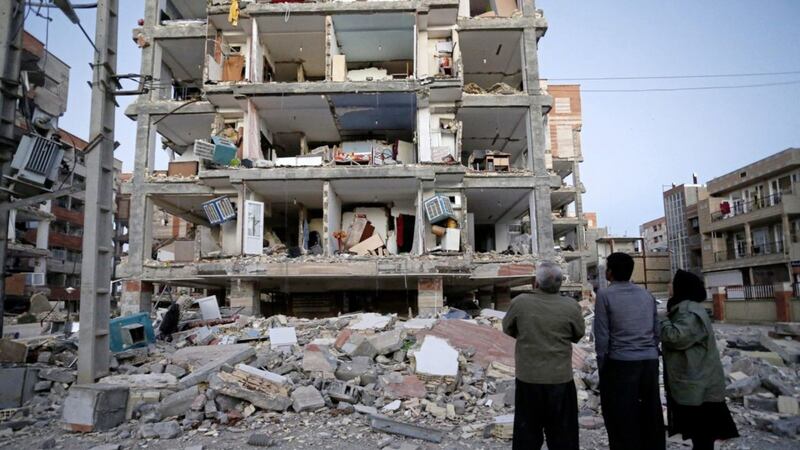 People look at destroyed buildings after an earthquake at the city of Sarpol-e-Zahab in western Iran on Monday. Picture by Pouria Pakizeh, ISNA via Associated Press 