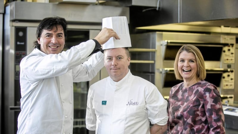Multi-Michelin-starred French chef Jean-Christophe Novelli &quot;crowns&quot; his new head chef Jim Mulholland as the AC Hotels by Marriott general manager Lisa Steele looks on 