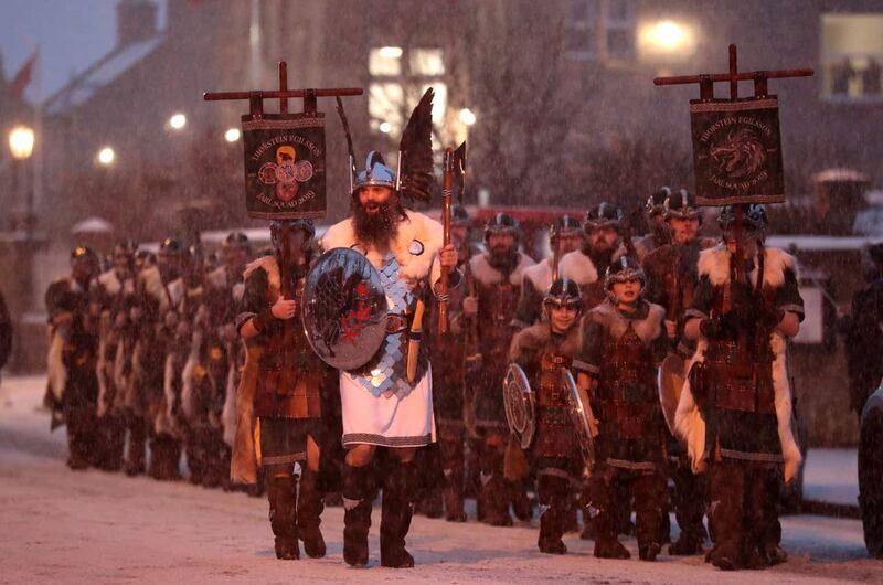 Guizer Jarl John Nicolson and his squad march through Lerwick as snow falls on the Shetland Isles during the Up Helly Aa Viking festival