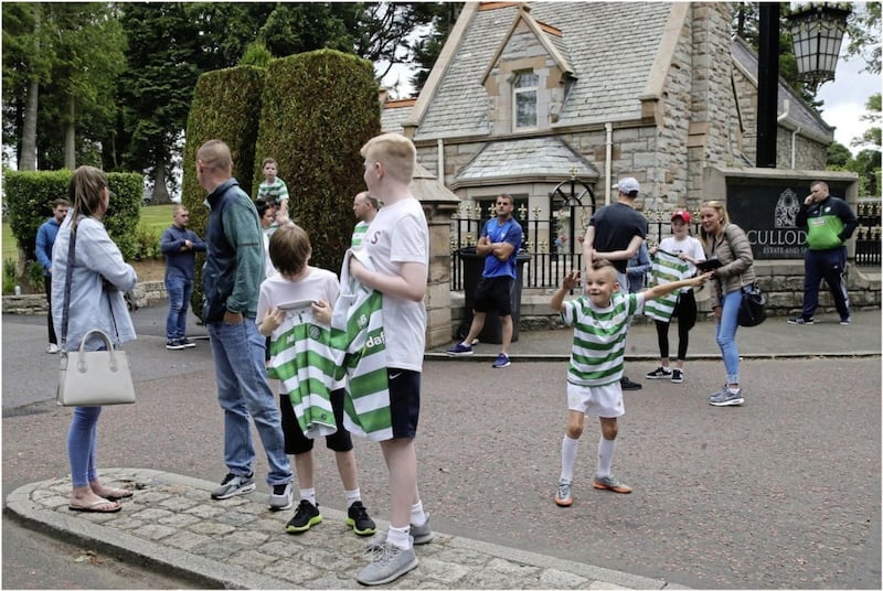 Celtic fans in high spirits as they await the arrival of the squad at the Culloden Hotel last night. Picture by Hugh Russell 