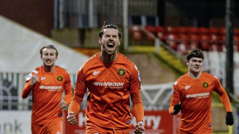 Carrick&#39;s Caolan Loughran celebrates after making it 3-1 from the penalty spot during Saturday&#39;s game at Seaview Picture by Andrew McCarroll/Pacemaker 