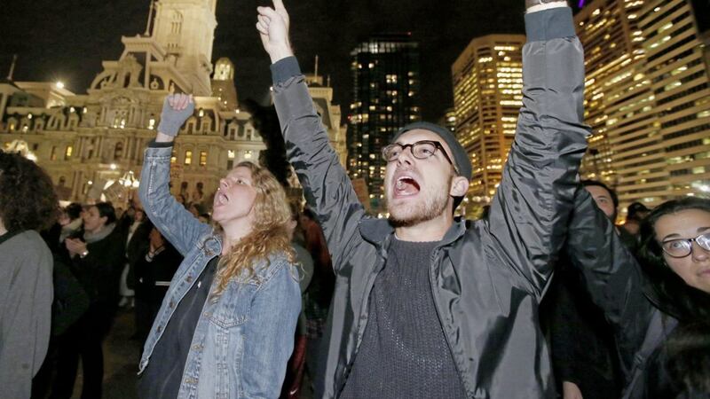 Melissa Goodwin and Evan Laudenslager join protesters unhappy with the presidential election at the Municipal Services Building plaza in Philadelphia. Picture by Charles Fox/The Philadelphia Inquirer via AP