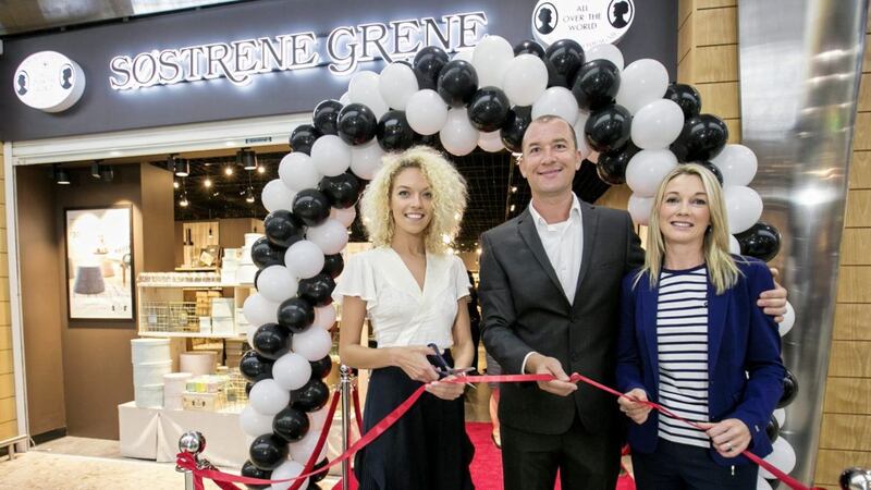 Niamh Cunningham is pictured with Richard and Norma Power at the opening of the new S&oslash;strene Grene store in Newry 