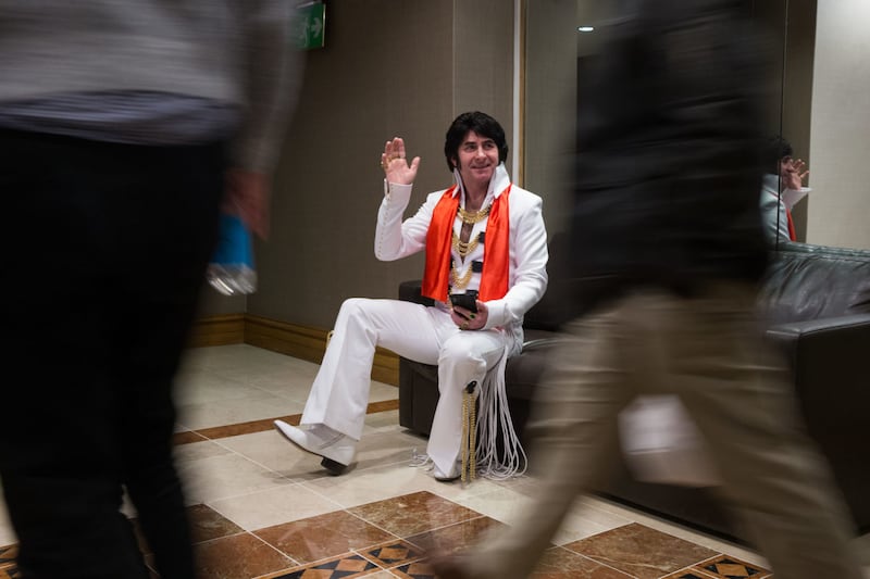 Mark Cumberland waves to passers by at Europe's largest annual Elvis Tribute Artist Content Convention