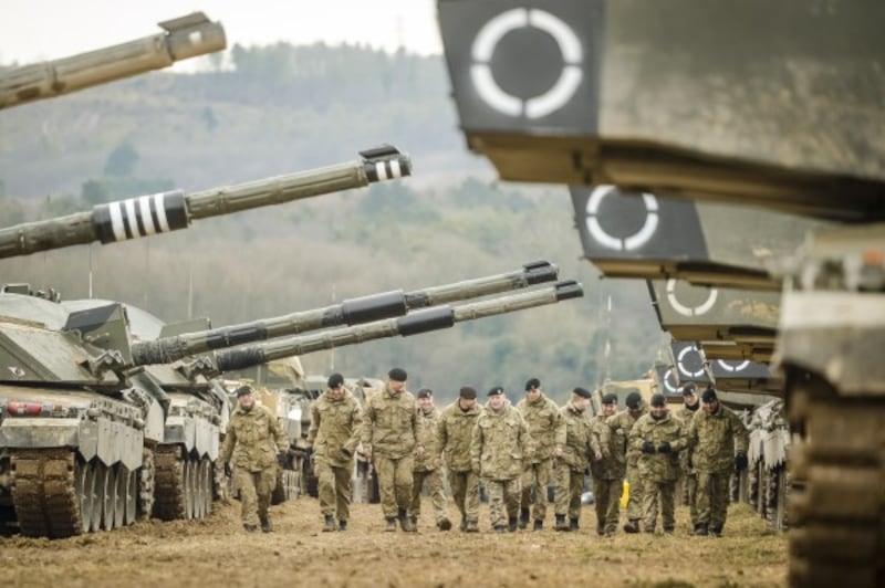 Soldiers from The Royal Tank Regiment walk through rows of Challenger II main Battle Tanks