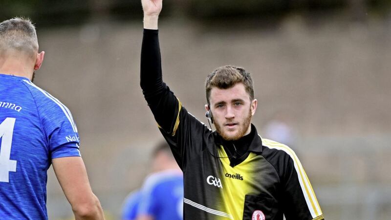 Tyrone referee Martin Coyle, dishes out a yellow card during his first championship match on Saturday. 