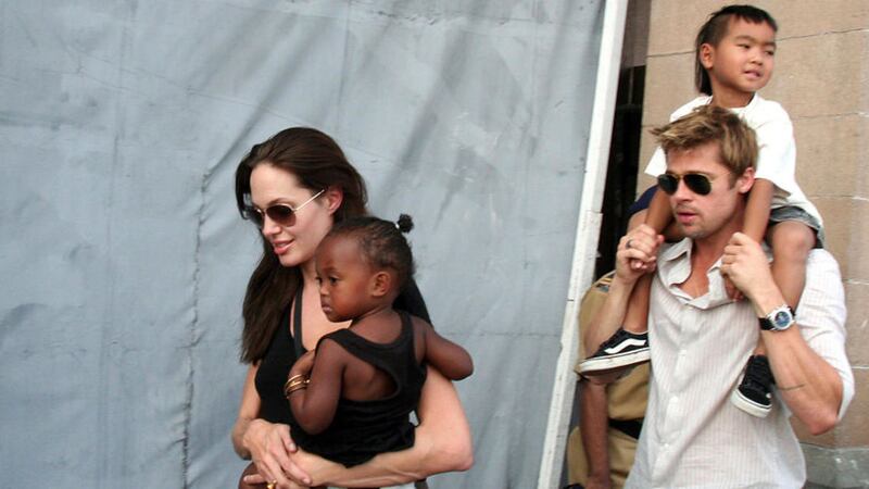 Angelina Jolie with her daughter Zahara, and Brad Pitt, with Jolie&#39;s son Maddox, pictured in India some years ago 