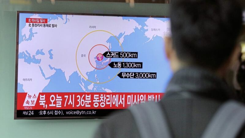 A TV news program, showing at Seoul Train Station South Korea, reports North Korea&#39;s missile firing Picture by Lee Jin-man/AP 