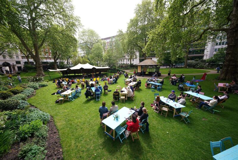 Londoners enjoy a performance by percussion group Beaten Track, during a free ticketed outdoor picnic concert in Portman Square Garden, organised by Wigmore Hall as part of its 120th anniversary celebrations