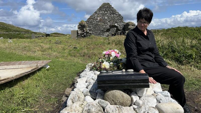 Marie Coyne at the grave of the thirteen skulls on Inishbofin (Marie Coyne)
