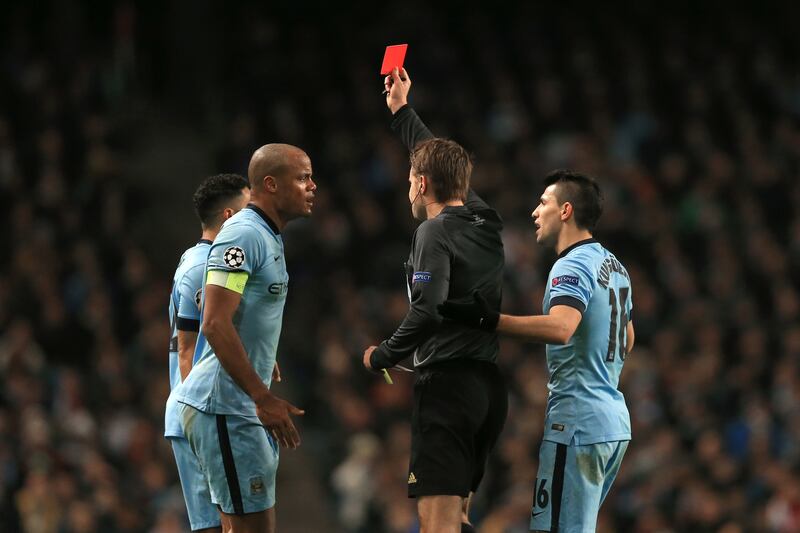 Man City's Gael Clichy, left, is shown the red card by ref Felix Brych.