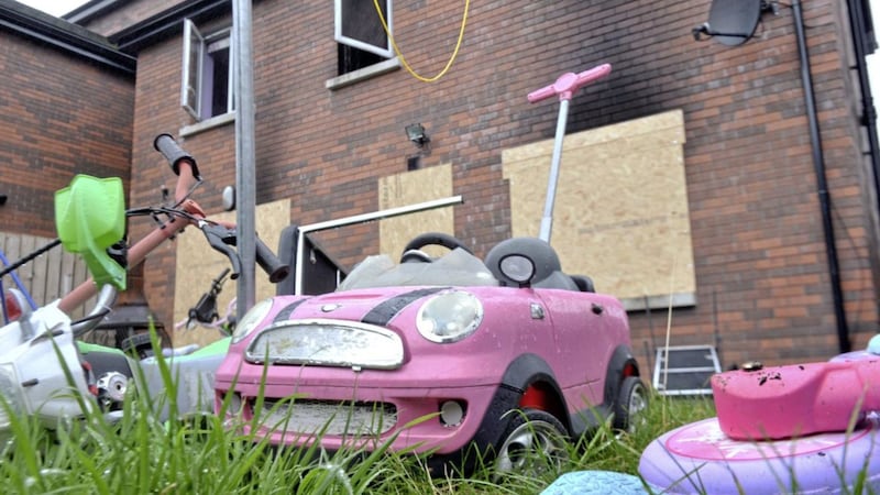 Children&#39;s toys lie in the back garden of the burnt-out family home in Queen Victoria Gardens, north Belfast. Picture by Alan Lewis, Photopress 