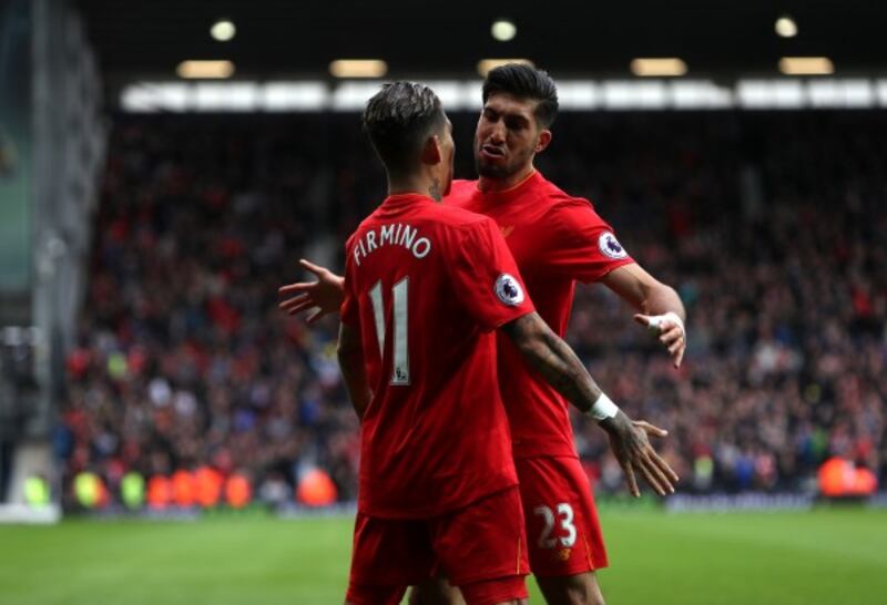 Liverpool's Roberto Firmino (left) celebrates scoring his side's first goal of the game with teammate Emre Can 
