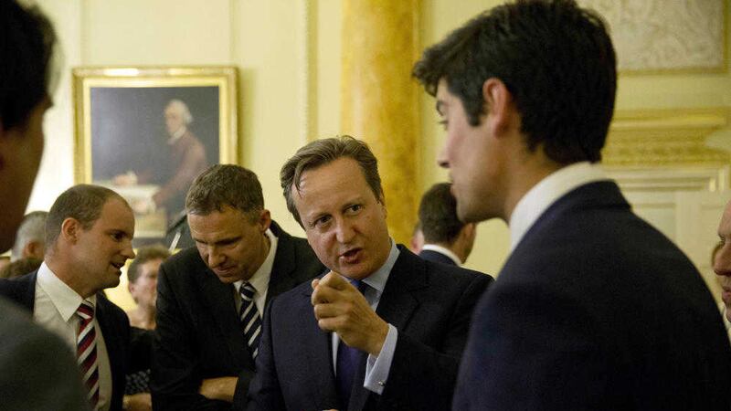 Prime Minister David Cameron (centre) chats with England captain Alastair Cook (right), during a reception to mark a successful summer of cricket at 10 Downing Street, London. Picture: Matt Dunham/PA Wire 