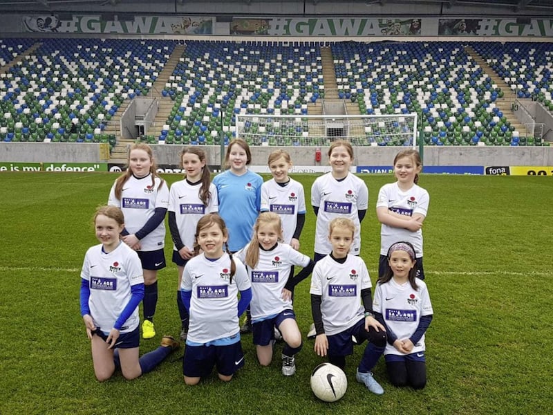 Cara (front row, second from left) with her Rosario Football Club team at Windsor Park 