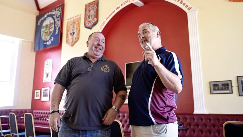Gary Watson (left) from Ballynafeigh Cultural and Heritage Society and Liam McKenna (right) from Bredagh GAC during a tour of Ballynafeigh Orange Hall in Belfast. Picture by Michael Cooper, Press Association