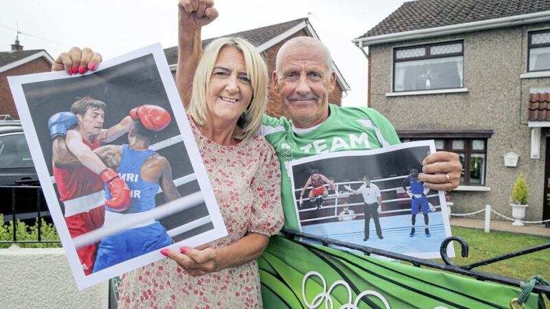 Damien and Martine Walsh celebrating at their west Belfast home after their boxer son, Aidan, fought his way into medal position at the Tokyo Olympics. Picture by Hugh Russell