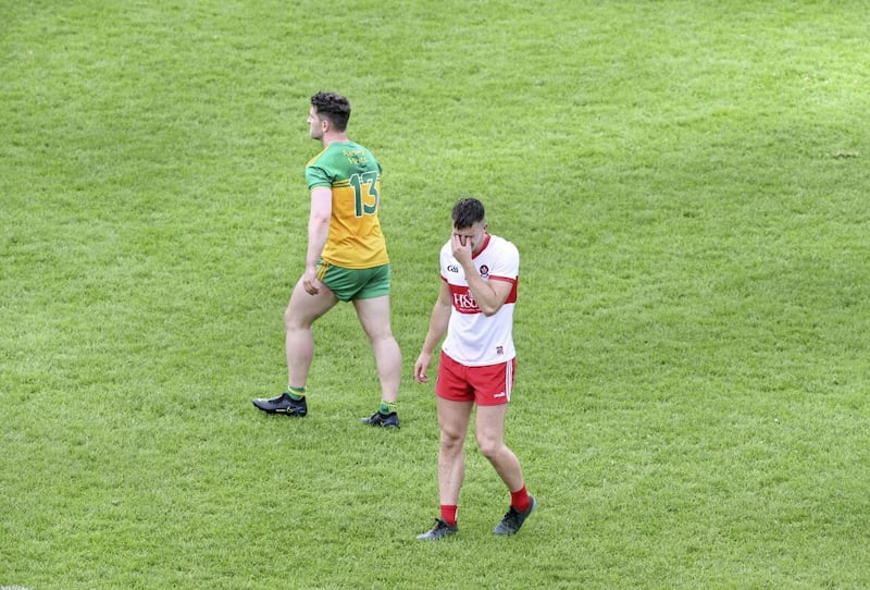 A devastated Shane McGuigan (right) of Derry after Patrick McBrearty (left) of Donegal kicked a late winner in 2021. Picture Margaret McLaughlin 