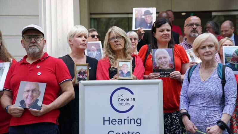 People hold pictures of loved ones lost during the pandemic outside Dorland House in London where the inquiry is hearing evidence for its first investigation (Module 1) examining if the pandemic was properly planned for and “whether the UK was adequately ready for that eventuality” (Lucy North/PA)