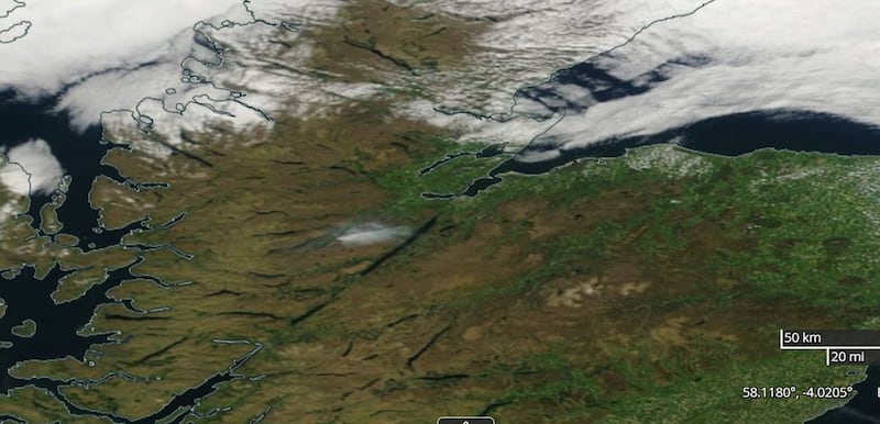 Screenshot from Nasa worldview satellite showing the plume of smoke (centre) from the fire at Cannich, in the hills above Loch Ness in the Highlands, drifting towards the loch on Monday amid clear skies 